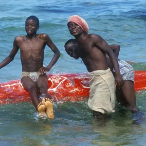Teenager with surfboard in Lake Malawi Teenager with surfboard in Lake Malawi