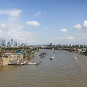 Thames River with visible boats and surrounding London architecture under a bright sky in London