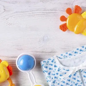 Things for a newborn on a white wooden background Things for a newborn on a white wooden background
