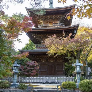 Three-story pagoda in a Japanese temple surrounded by colorful autumn leaves Three-story pagoda in a Japanese temple surrounded by colorful autumn leaves