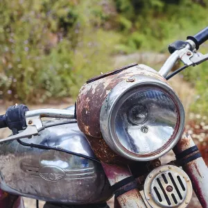 The thrown abandoned old rusty brown vintage motorcycle