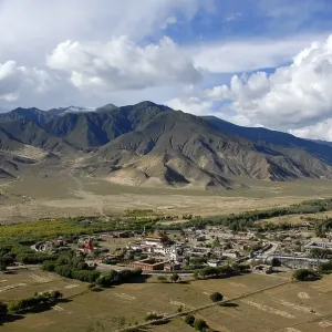 Tibetan Buddhism, circular shaped monastery in the form of a mandala under the hillside Tibetan Buddhism, circular shaped monastery in the form of a mandala under the hillside