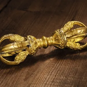 Tibetan Buddhist Dorje vajra ceremonial item on wooden background