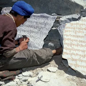 Tibetan Buddhist mantras carved in stone by man