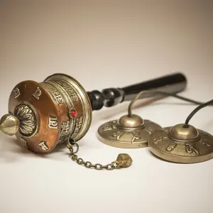 A Tibetan prayer mill and cymbals A Tibetan prayer mill and cymbals