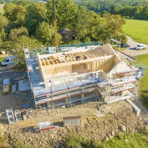 Timber frame construction with scaffolding and crane