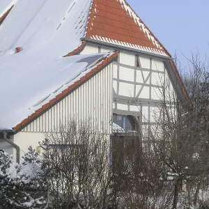 Timbered house, Ludersen mountain village snowed in winter after snowstorm Elli