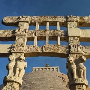 Toran or sacred gateway with stone reliefs at the Buddhist stupa