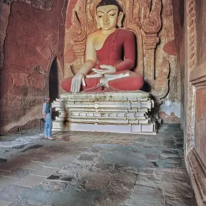 Tourist and Buddha figure in Htilominlo Temple