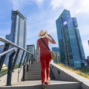 Tourist wearing a straw hat walking up stairs in vancouver