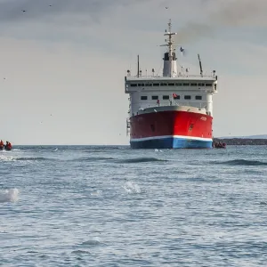 Tourist in zodiacs around a expedition ship