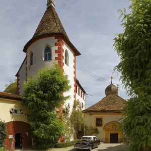 Tower, church on the right and forecourt with vintage Opel Kapitaen