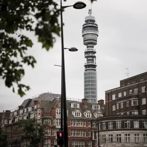 Tower rises above city buildings against a cloudy sky in Greater London Tower rises above city buildings against a cloudy sky in Greater London