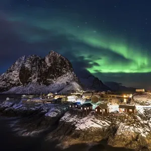 Town and fisherman's cabins or Rorbus in front of snowy mountains