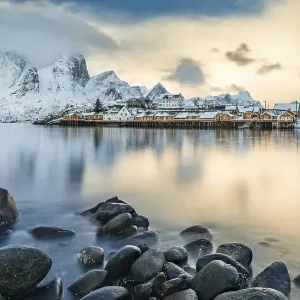 Town and fisherman's cabins or Rorbus in front of snowy mountains Town and fisherman's cabins or Rorbus in front of snowy mountains