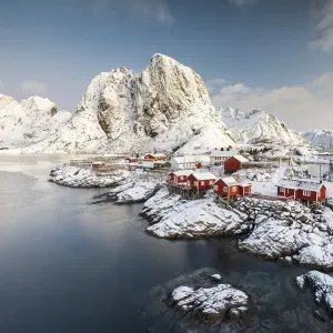 Town and fisherman's cabins or Rorbus in front of snowy mountains Town and fisherman's cabins or Rorbus in front of snowy mountains