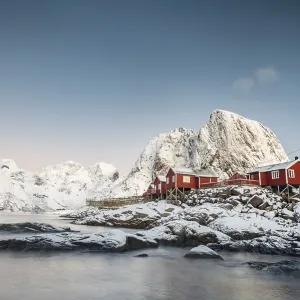Town and fisherman's cabins or Rorbus in front of snowy mountains Town and fisherman's cabins or Rorbus in front of snowy mountains