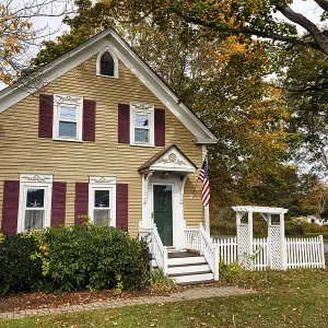 Traditional colonial house, fall leaves Traditional colonial house, fall leaves