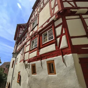 Maison traditionnelle à colombages avec des poutres rouges distinctives et des éléments de façade blancs en Bad Wimpfen.