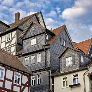 Traditional half-timbered houses with tiled roofs and cloudy skies Traditional half-timbered houses with tiled roofs and cloudy skies