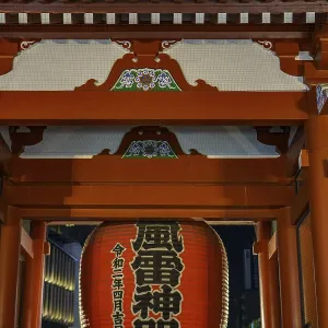 A traditional Japanese temple with a large red lantern at night A traditional Japanese temple with a large red lantern at night
