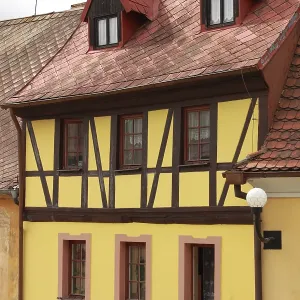 Traditional timbered house with red roof clay tiles