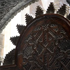 Traditional wooden door with complex Islamic decorations in Medersa Attarine