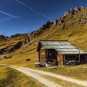 Trail with alpine hut and South Tyrolean mountains Trail with alpine hut and South Tyrolean mountains