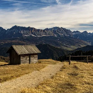 Trail with alpine hut and South Tyrolean mountains