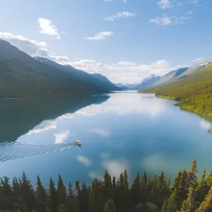 A tranquil lake reflecting the surrounding mountains and forest