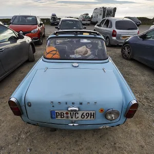 Triumph convertible, light blue vintage car in a car park