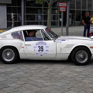 Triumph GT6, stylish white classic car taking part in a rally