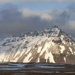 Typical Icelandic landscape with mountains and meadow land covered in snow at snaefellsnes peninsula in Iceland Typical Icelandic landscape with mountains and meadow land covered in snow at snaefellsnes peninsula in Iceland