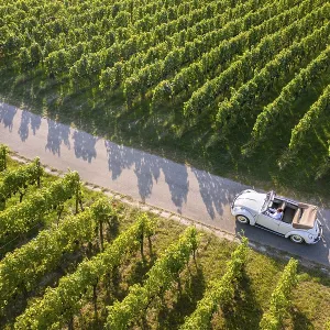 UAV recording, businessman in a vintage car