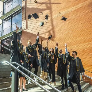 University Graduates Celebrating with Cap Toss Print