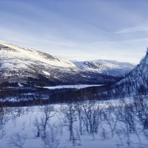 Vast snow-covered mountain landscape under a blue sky Vast snow-covered mountain landscape under a blue sky