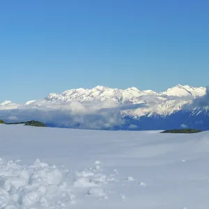 Vast snowy landscape with views of white mountain peaks in South Tyrol and blue skies Vast snowy landscape with views of white mountain peaks in South Tyrol and blue skies