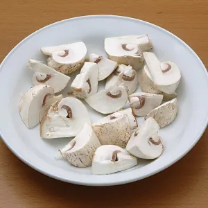Vegetable, white button mushroom shape chopped mushroom in the plate Vegetable, white button mushroom shape chopped mushroom in the plate