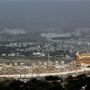 View of Agadir with the Kasbah and a large parking lot in the foreground