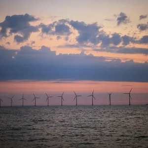View from Amager beach to wind turbines in the sea at sunrise View from Amager beach to wind turbines in the sea at sunrise