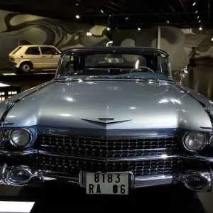Front view of a blue vintage car with distinctive headlights