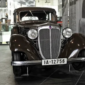 Front view of a brown classic car with classic design Front view of a brown classic car with classic design