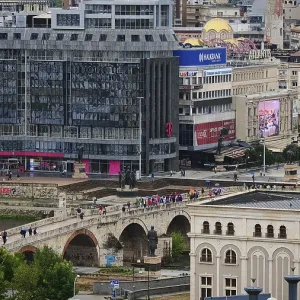 View of a city with a modern building and a bridge