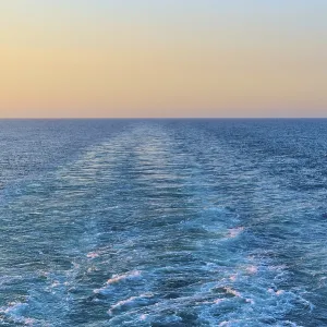View from the cruise ship at sunset at the stern of the ship onto the stern waves View from the cruise ship at sunset at the stern of the ship onto the stern waves