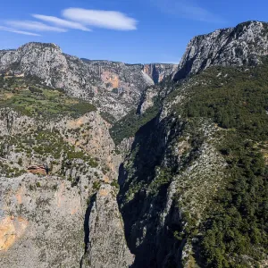 View of an extensive canyon landscape with rugged rocks and lush greenery