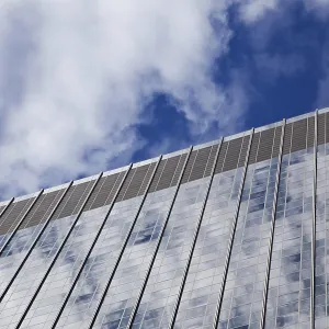 View up a glass skyscraper facade in Manhattan