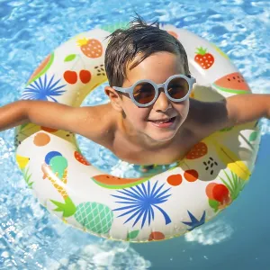 Top view of a happy young boy inside a blue swimming pool with swim goggles and a float Top view of a happy young boy inside a blue swimming pool with swim goggles and a float