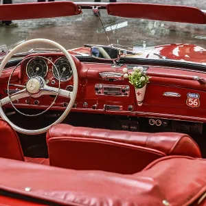 View into interior of convertible classic car Mercedes SL 190 with red leather View into interior of convertible classic car Mercedes SL 190 with red leather