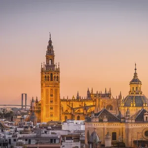 View of La Giralda and Iglesia del Salvador at sunset