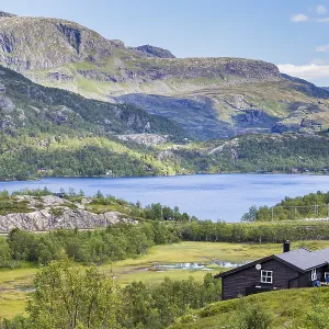 View on lake and wooden house from the most beautiful train journey Flamsbana between Flam View on lake and wooden house from the most beautiful train journey Flamsbana between Flam
